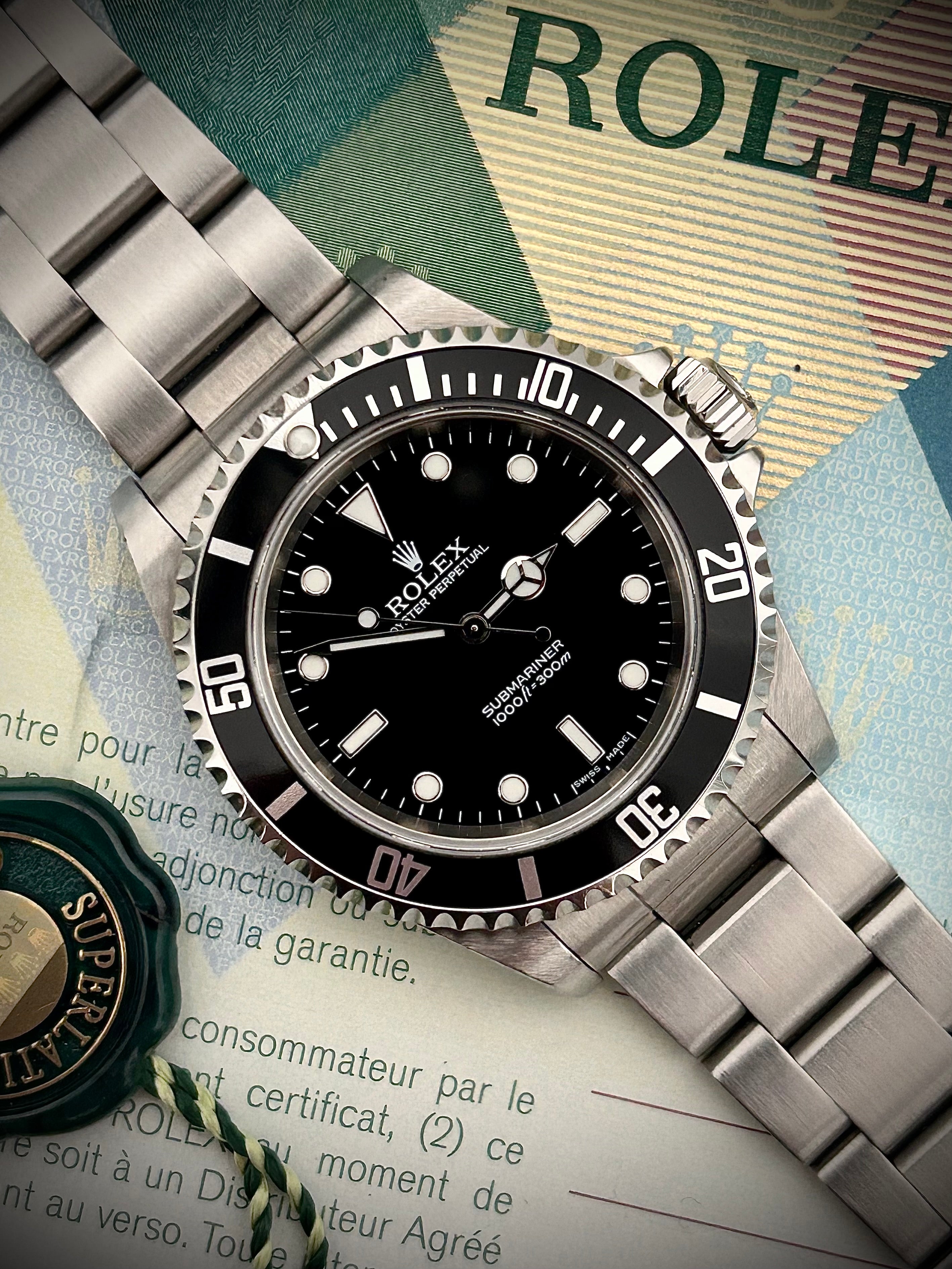 2006 ROLEX SUBMARINER TWO-LINER 14060M, WATCH AND PAPERS, INC GST