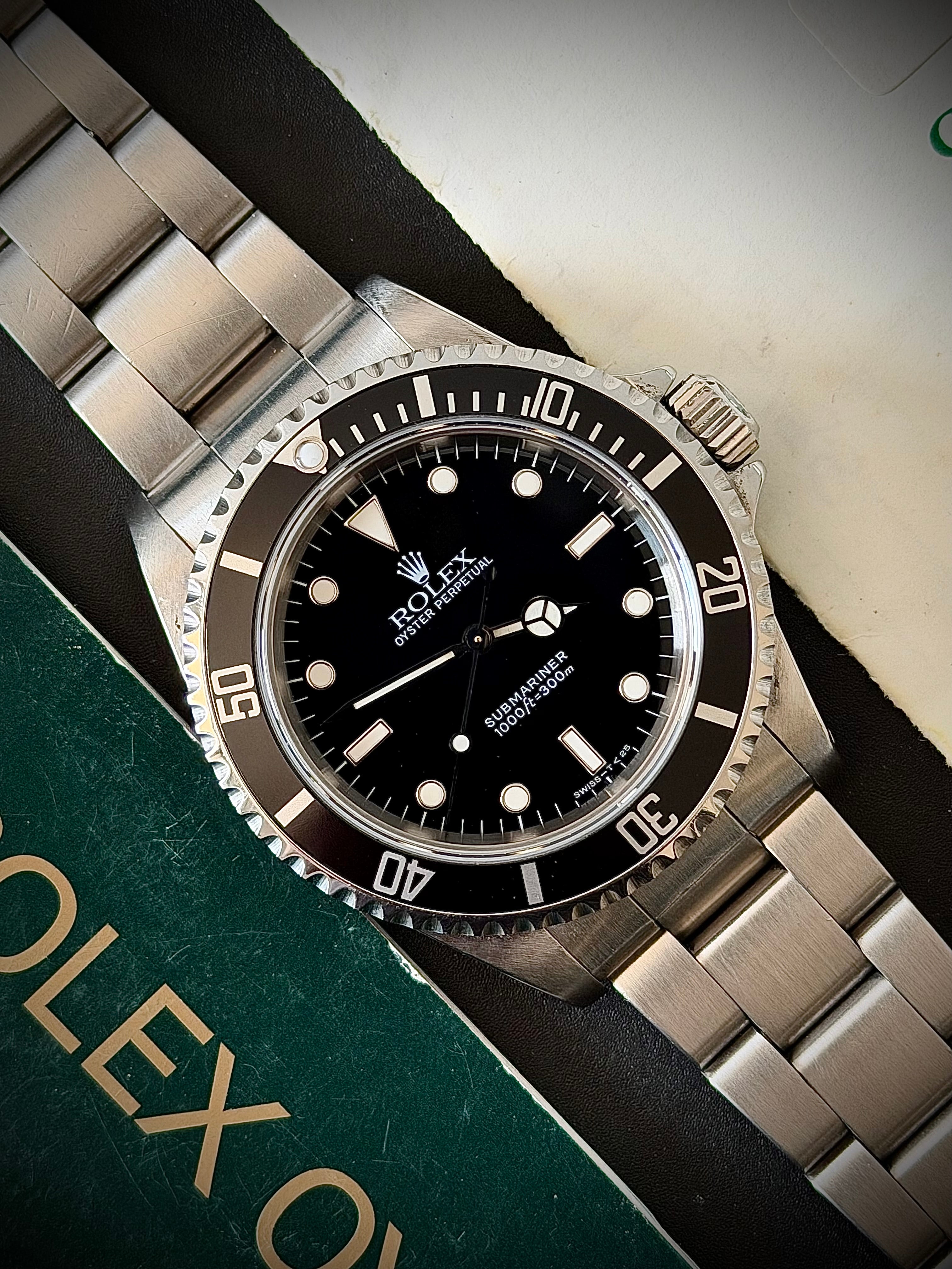 1997 ROLEX SUBMARINER NO-DATE, TWO LINER, 14060, BOX AND PAPERS, INC GST